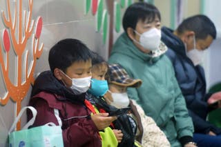Pictured: Masked children wait for a visit at a hospital in Hangzhou amid a surge in HMPV cases.